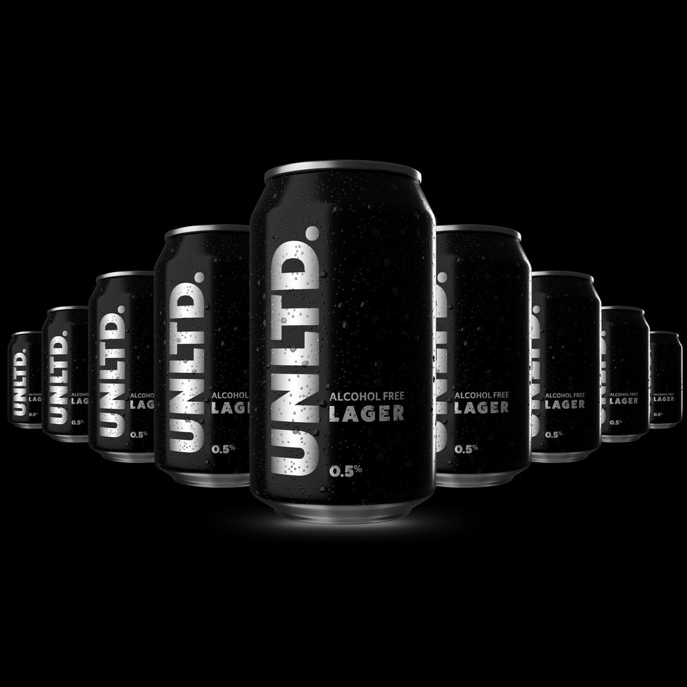 Multiple cans of UNLTD alcohol-free lager on a black background