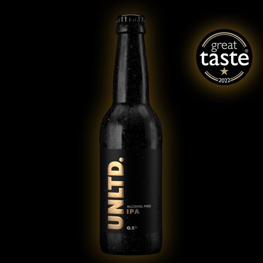 A bottle of UNLTD non-alcoholic IPA with a 'Great Taste 2022' award logo.